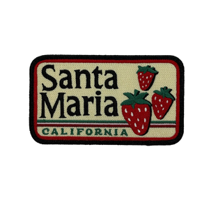 An embroidered rectangular patch featuring the text 'Santa Maria CALIFORNIA' with three red strawberries on a cream background, outlined in black and red.